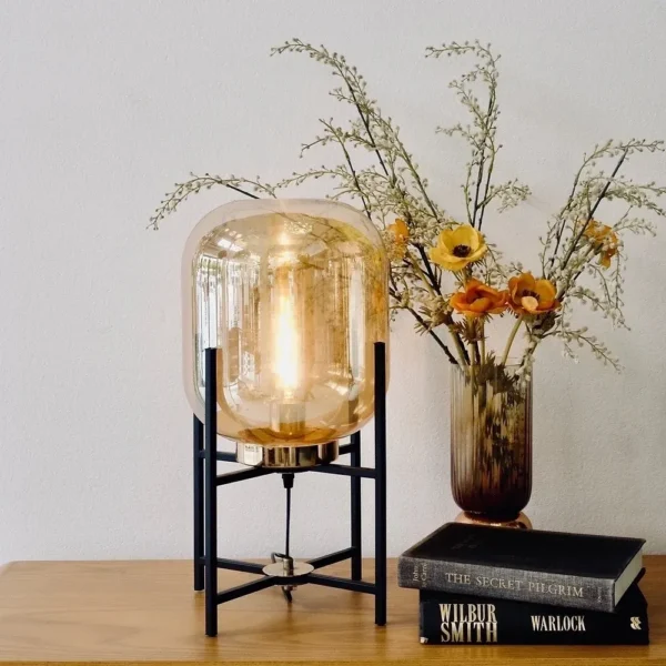 glass table lamp beside books