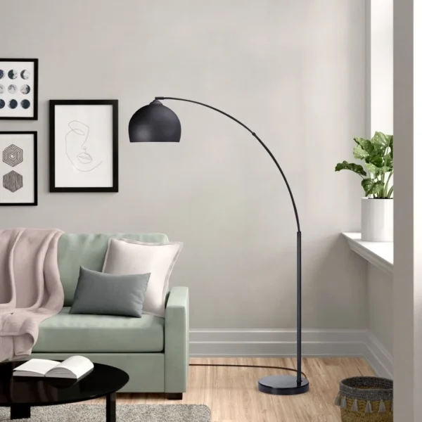 overhead Floor lamp with long bent stand black beside the couch